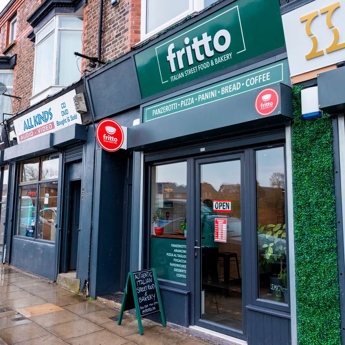 Fritto Italian Street Food shopfront with a green fascia and an open sign on the door.