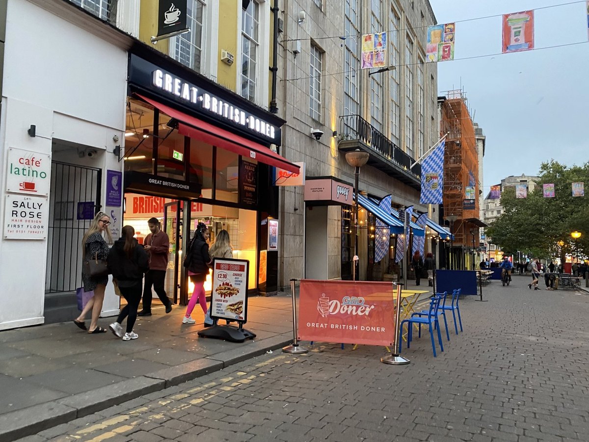 Great British Doner storefront on a Liverpool street, with a red and white fascia and a banner outside.