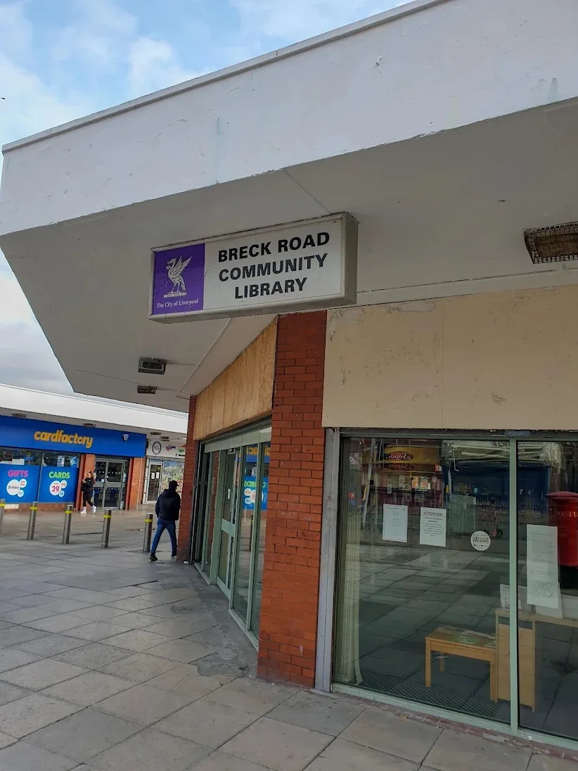 The closed Breck Road Community Library on The Mall, Breck Road, with its City of Liverpool sign above glass doors and an empty room behind the windows
