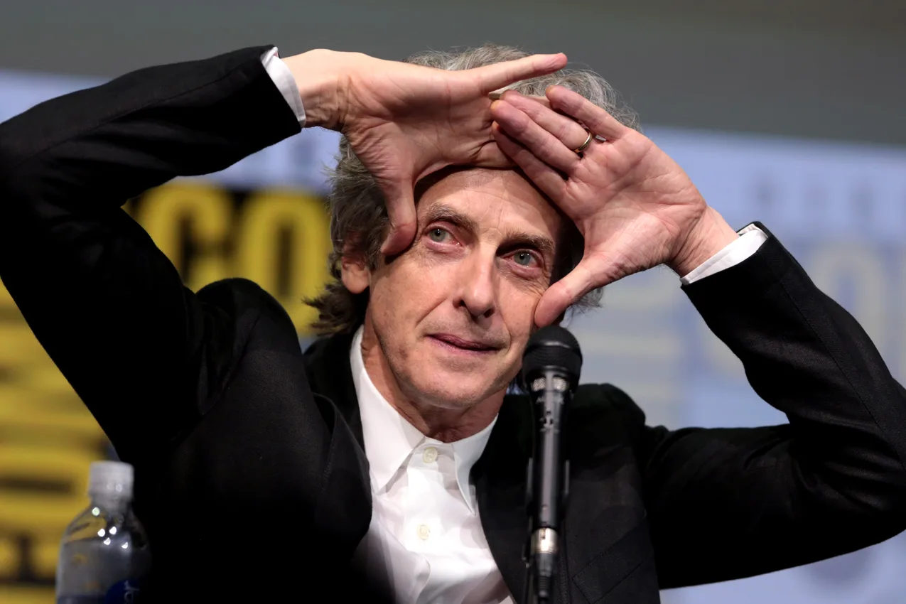 Doctor Who star Peter Capaldi speaking on stage into a microphone at Comic-Con