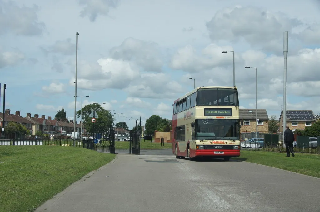 A double-decker bus turning in at one of the road entrances to Croxteth Country Park