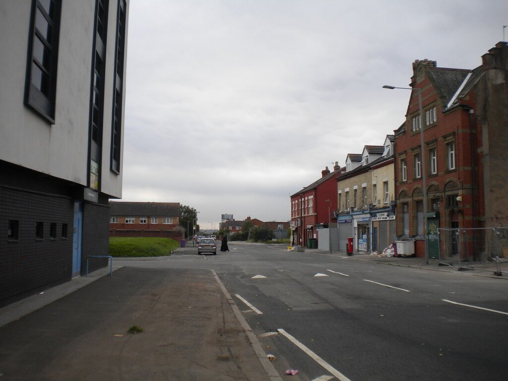Upper Stanhope Street in Toxteth today, a quiet street of red-brick terraces and a modern building.