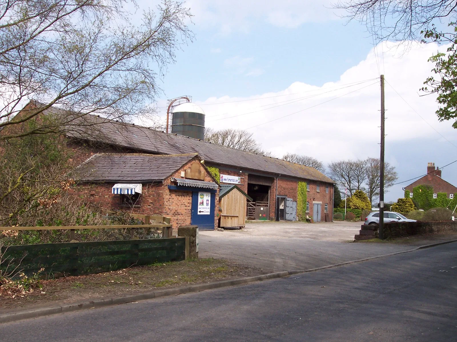Farmer Ted's Farm buildings and yard seen from Flatman's Lane in Downholland near Ormskirk