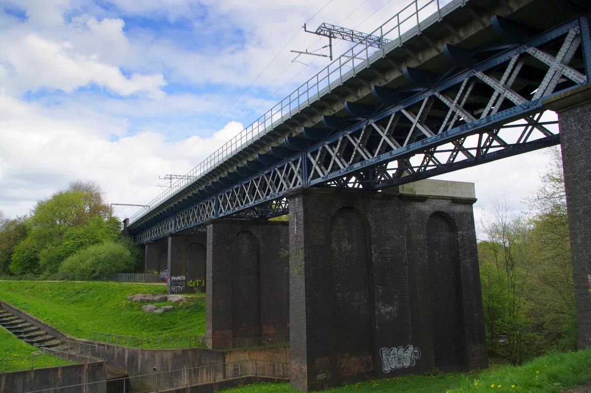 Stone railway viaduct carrying the line across water at Carr Mill, St Helens