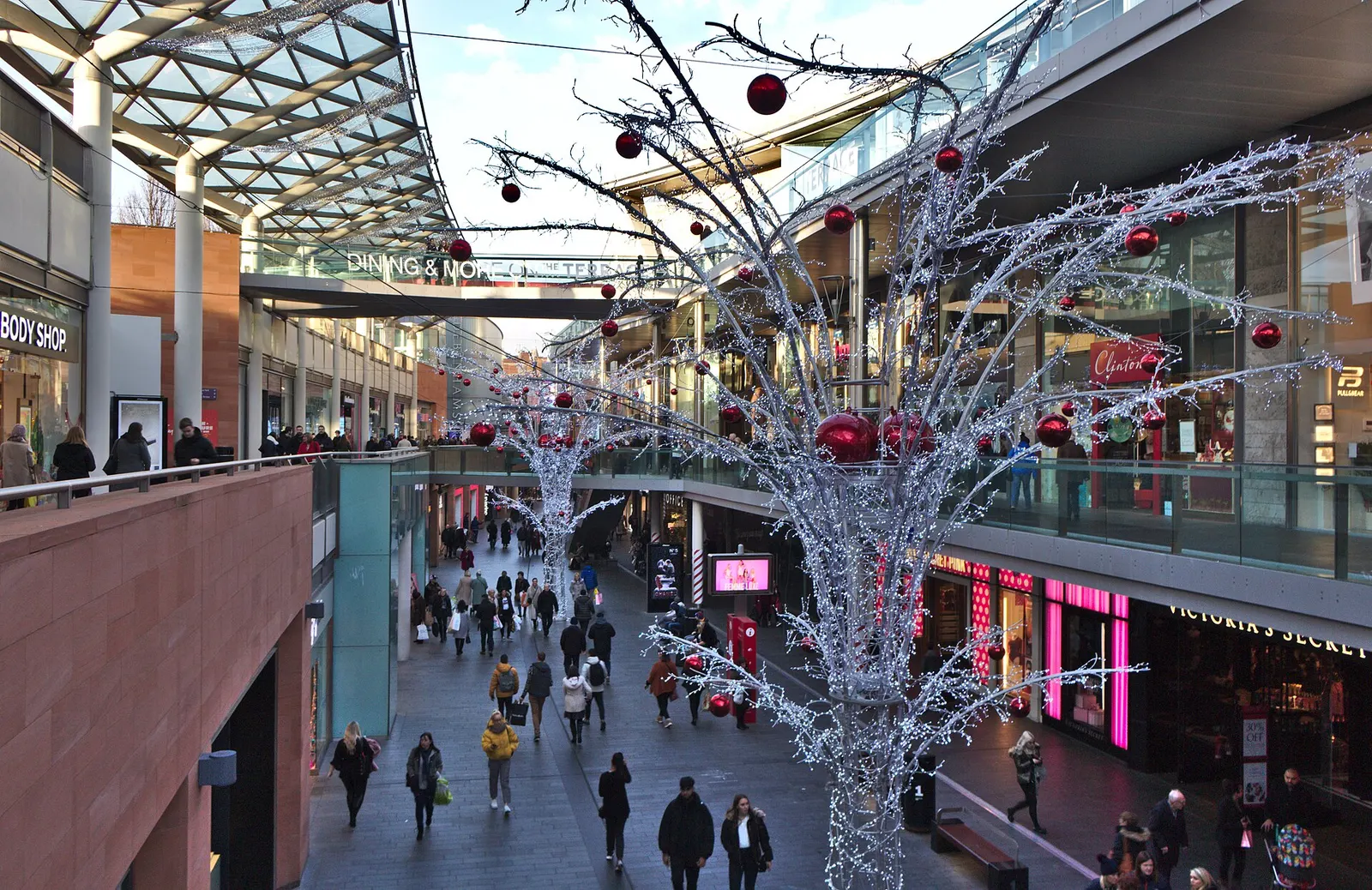 Silver Christmas decorations hanging above shoppers on South John Street at Liverpool ONE