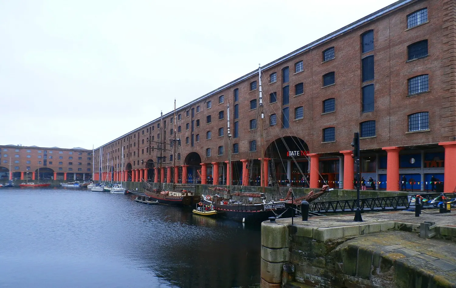 The brick and cast iron warehouses of Liverpool's Albert Dock reflected in the dock water