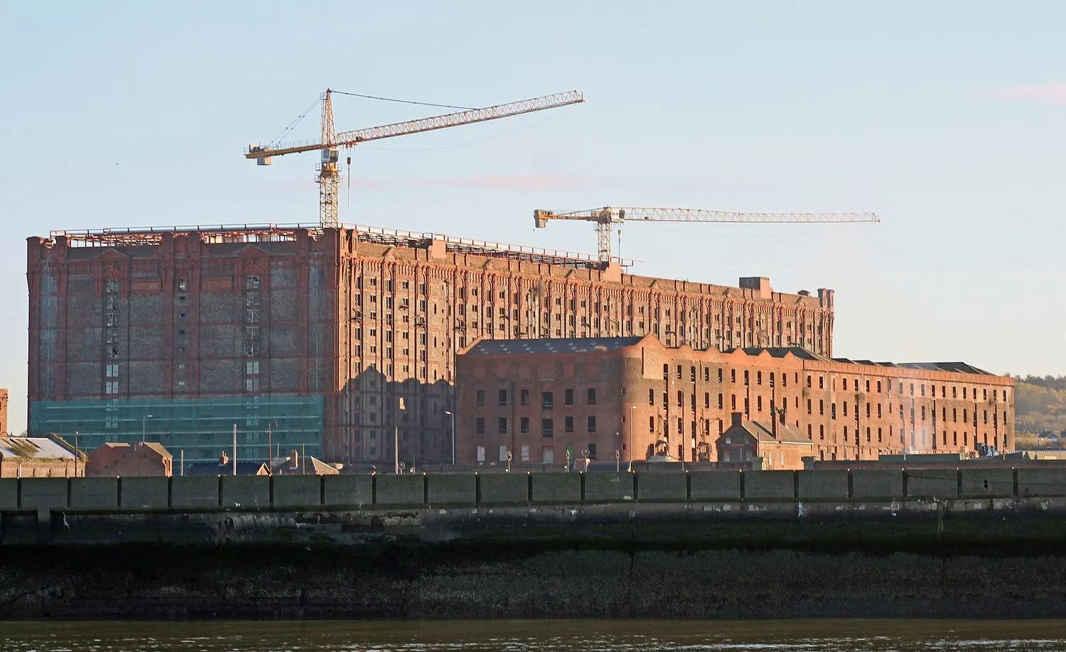 The vast brick Tobacco Warehouse at Stanley Dock in Liverpool seen across the dock basin