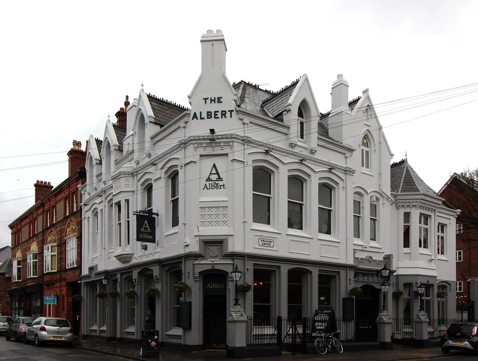 The Albert pub on the corner of Lark Lane, a white rendered Victorian building with bay windows