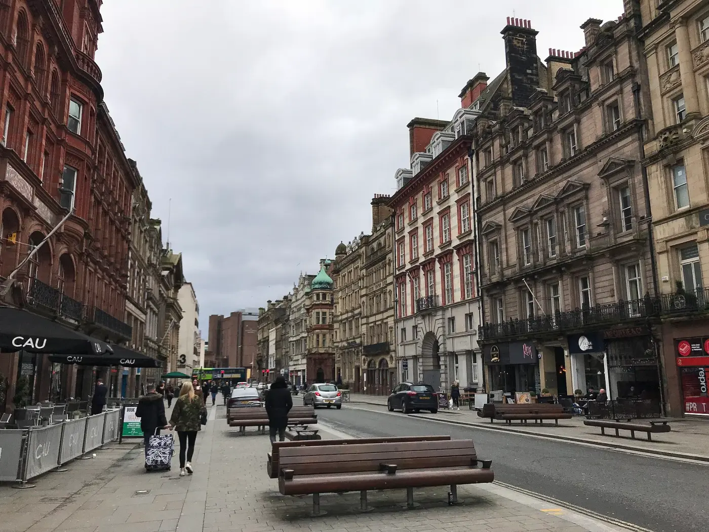 Castle Street in Liverpool lined with tall Victorian stone office buildings, looking towards the Town Hall