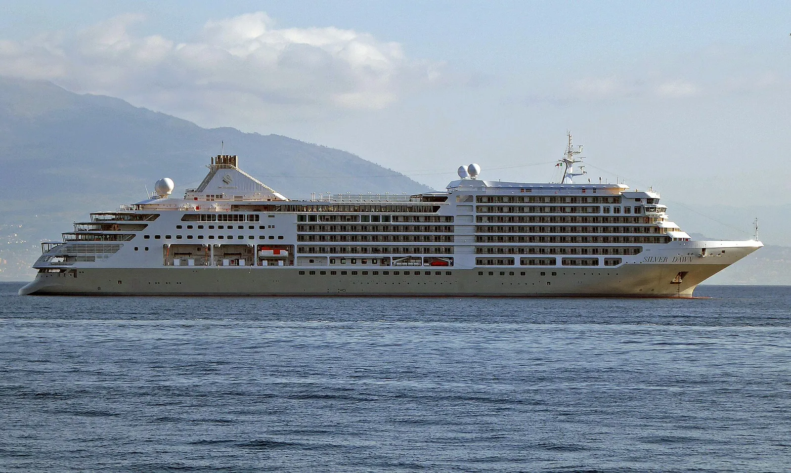 The cruise ship Silver Dawn seen side-on at anchor off Sorrento with hills behind