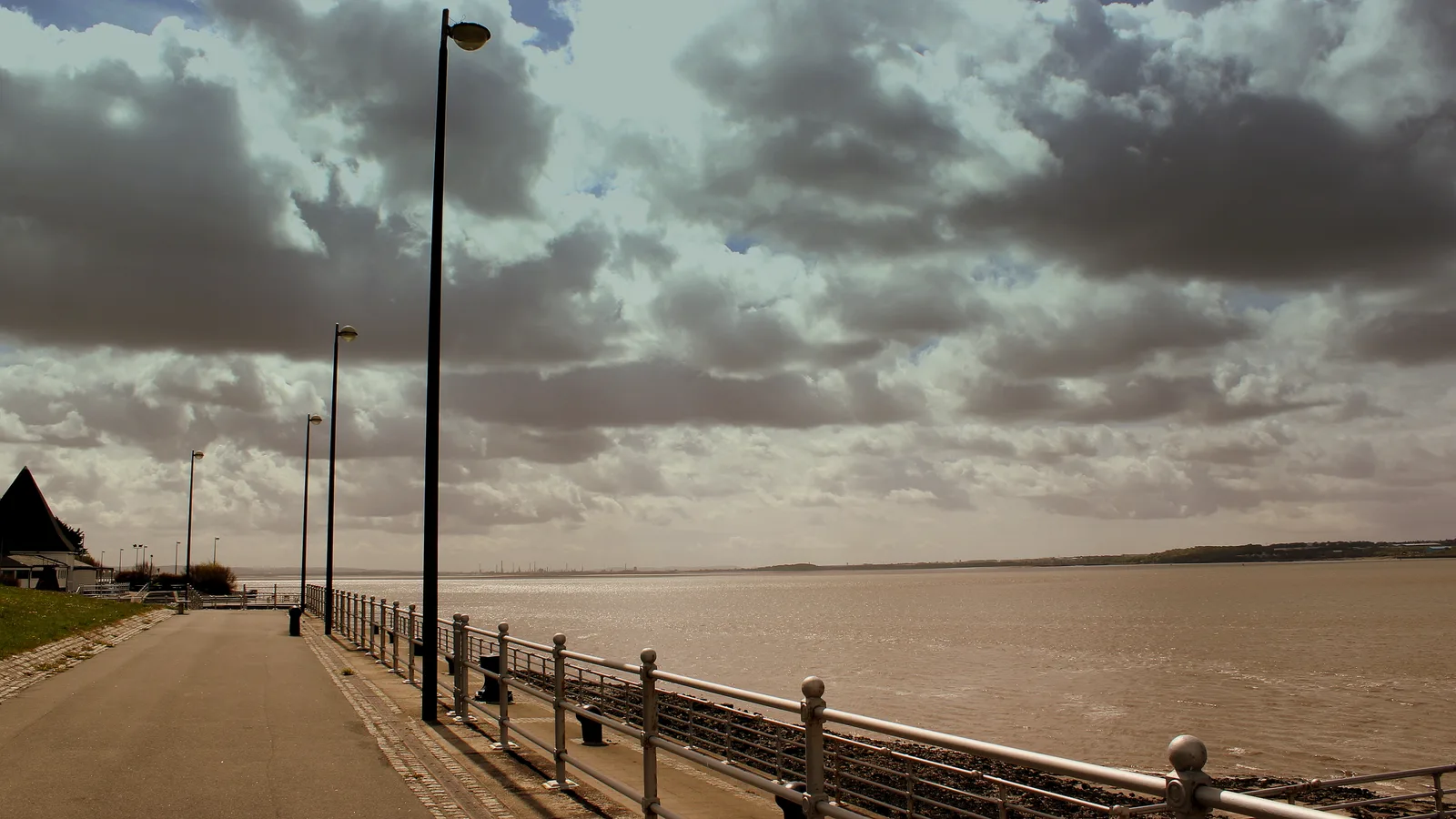 Otterspool Promenade beside the River Mersey in May 2013, with a wide paved walkway, railings and the open river on the right