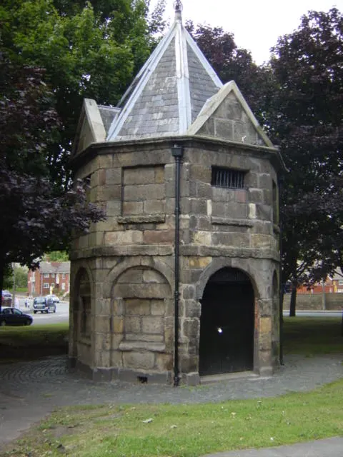 The small round stone Wavertree Lock-up of 1796 on its grass island