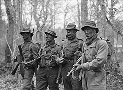 A group of armed men in field clothing