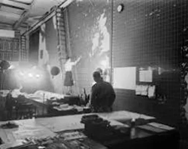 A wartime operations room with a wall-sized map and staff at work