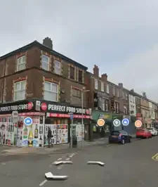 Perfect Food Store on West Derby Road, a convenience store frontage advertising groceries, drinks and vaping products.