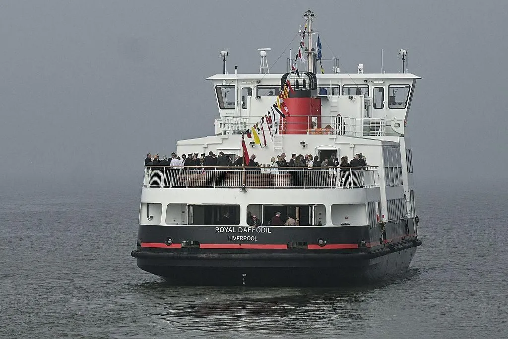 Guests on the upper deck at the stern of Royal Daffodil, with bunting flying and the name Royal Daffodil, Liverpool on the hull