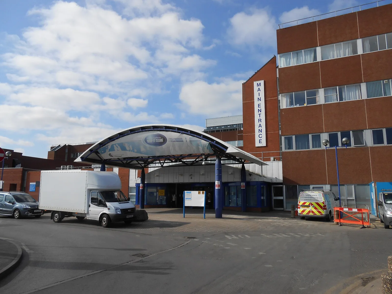 The main entrance canopy and red-brick buildings at Arrowe Park Hospital