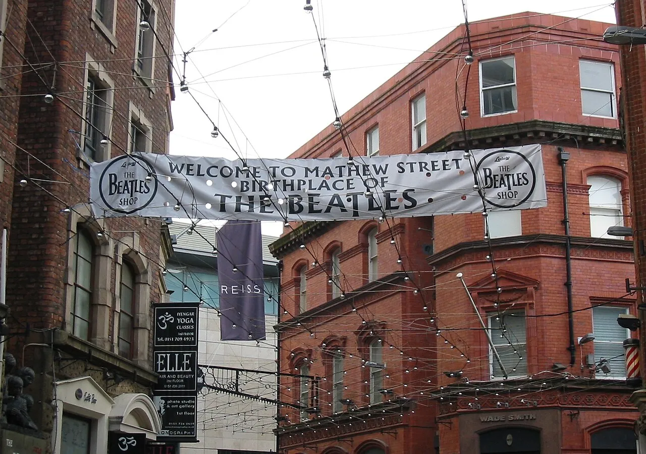 The narrow pedestrianised length of Mathew Street in Liverpool with venue signs along both sides
